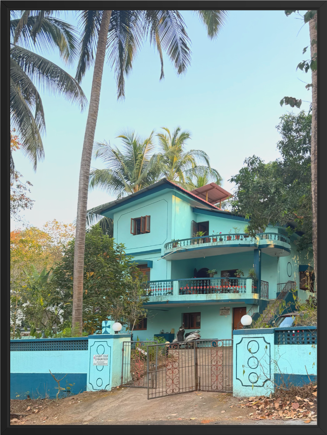 Colorful tropical house photography art print featuring a blue house surrounded by palm trees and lush greenery.