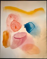 A framed abstract painting with primarily pink, blue, yellow, and orange colors on a white background.